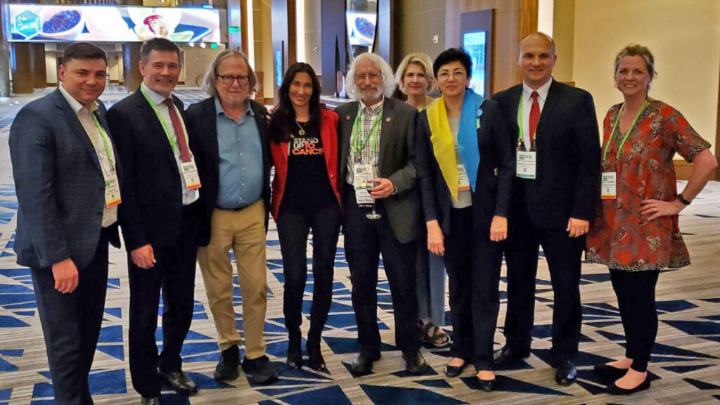 Oncology researchers standing together at the AACR annual meeting.