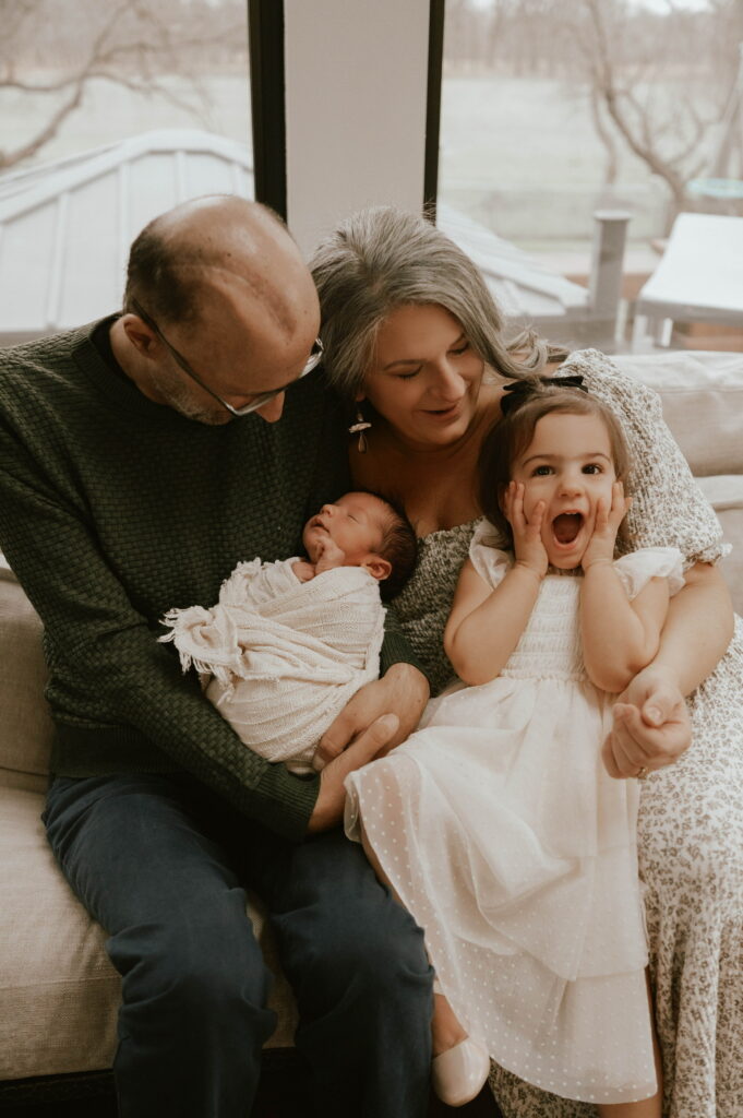 Abdallah poses in his home with wife Shauna and children.