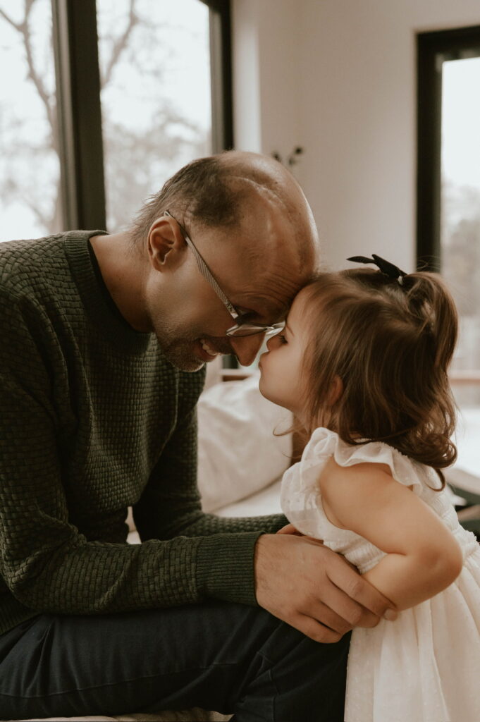 Abdallah and Nadia press their foreheads together.