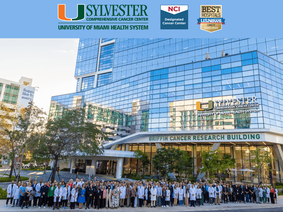 Large group of researchers and staff pose outside the Sylvester Comprehensive Cancer Center’s Kenneth C. Griffin Cancer Research Building.