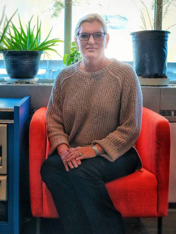 Dr. Taube sits in a red chair facing forward.