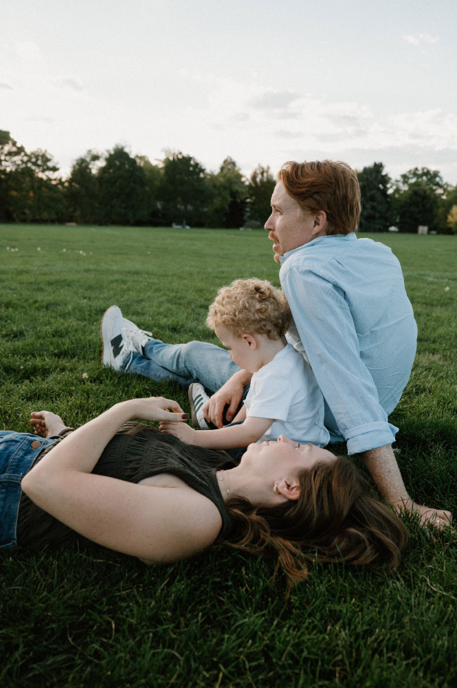 Herzer and his family sitting in the grass.